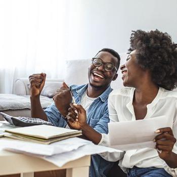 A couple celebrates paying off a credit card.