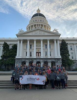 Patelco team members at the Credit Union for Kids Sactown Run event photo with the capitol in the background